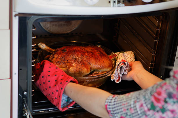 istock Woman taking out roasted duck 944975742