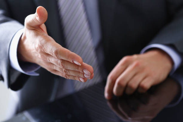 istock Man in suit and tie give hand as hello 944975878