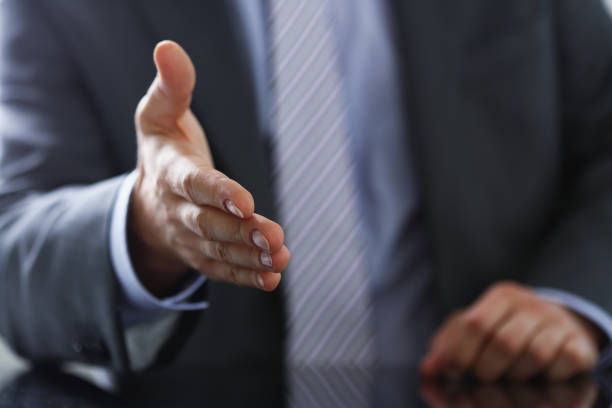 istock Man in suit and tie give hand as hello 944975894