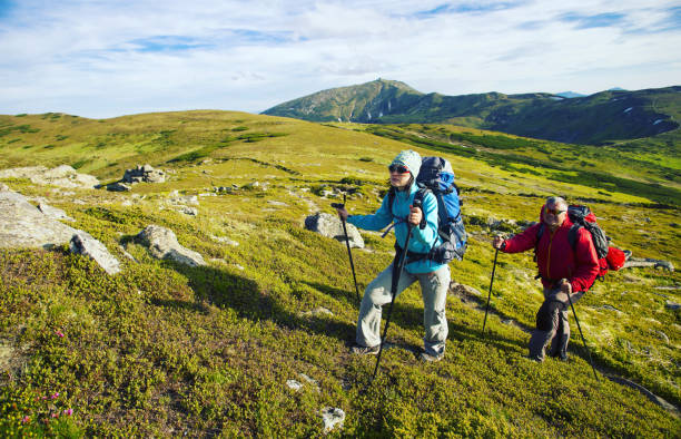 istock Summer hike in the mountains with a backpack and tent. 944976372