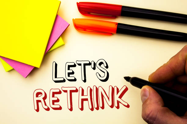 istock Handwriting text writing Let Us Rethink. Concept meaning Give people time to think things again Remodel Redesign written by Marker on the plain background Pen and Sticky Notes next to it. 944976562