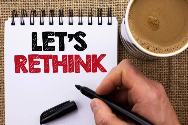 Text sign showing Let Us Rethink. Conceptual photo Give people time to think things again Remodel Redesign written by Man Holding Marker Notebook Book the jute background Coffee Cup.
