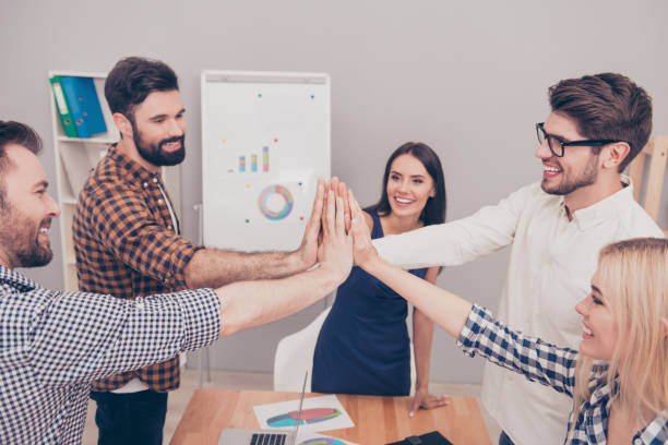 istock Happy smilling colleagues giving high five to each other 944979132
