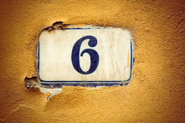 istock Number six enamel door number on plaster wall 944979314