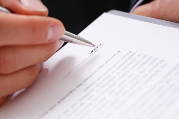 istock Male arm in suit offer contract form on 944979826
