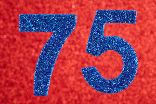 istock Number seventy-five blue color over a red background. Anniversary 944983056