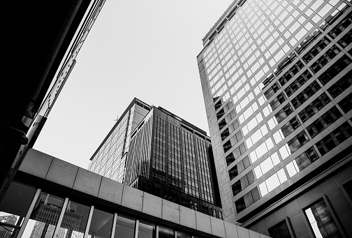 Bottom up view of Modern office building in Hong Kong with B&W color