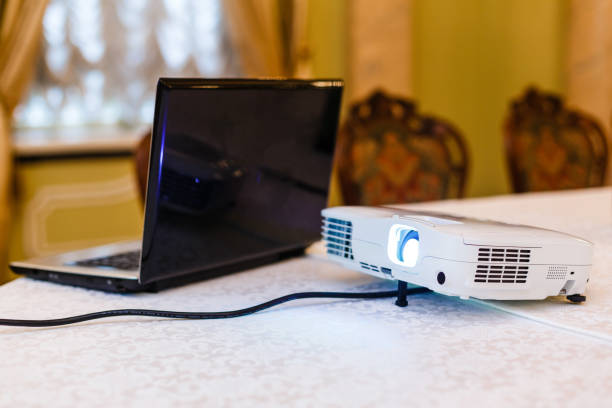 istock Laptop on table and speaking man at business meeting 944983386