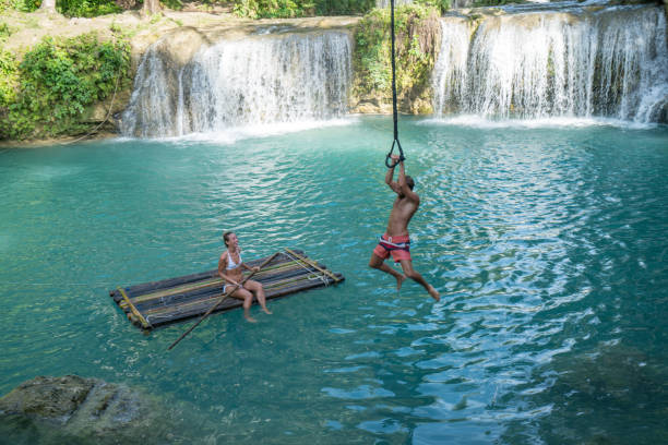 istock Young couple playing at beautiful waterfall in the Philippines 944983716