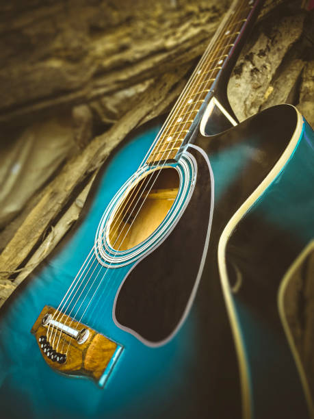 istock Acoustic guitar in rustic wooden background. 944983894