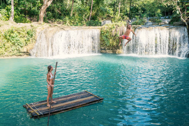 istock Young couple playing at beautiful waterfall in the Philippines 944984096