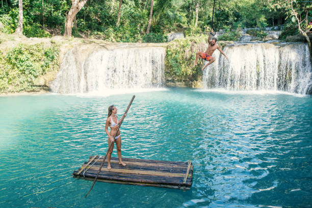 istock Young couple playing at beautiful waterfall in the Philippines 944986232