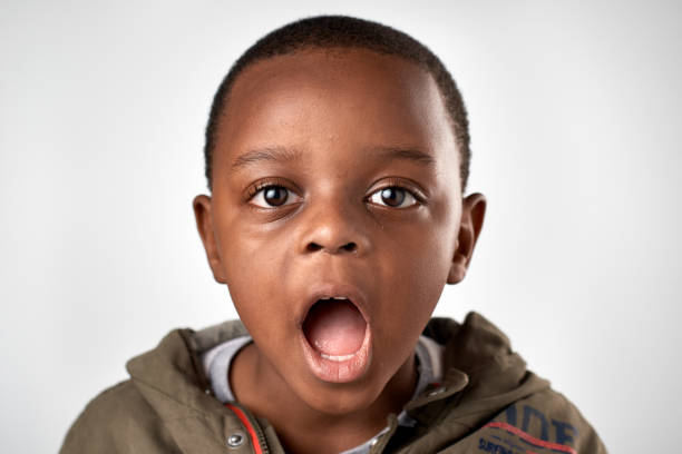 istock Studio portrait of young African boy making a silly face expression 944986558
