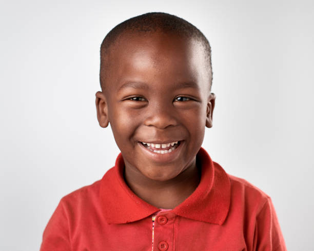 istock Studio portrait of happy cute African boy laughing 944986814