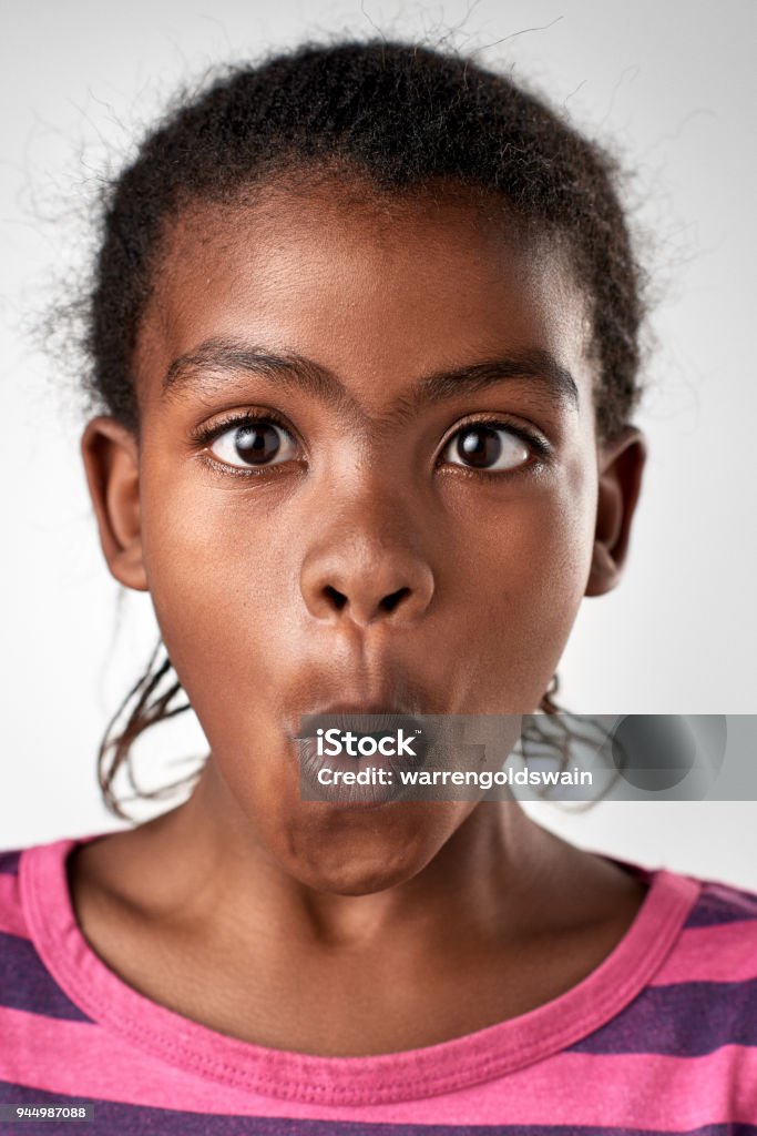 Studio Portrait Of Young African Girl Making Funny Silly Face Stock Photo -  Download Image Now - iStock