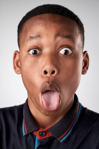 istock Studio portrait of young African boy pulling fun silly face 944987374