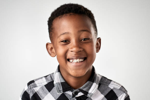 istock Studio portrait of African boy smiling laughing 944987742