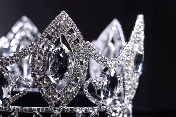 Diamond Silver Crown for Miss Pageant Beauty Contest, Crystal Tiara jewelry decorated gems stone and abstract dark background on black velvet fabric cloth, Macro photography copy space for text logo
