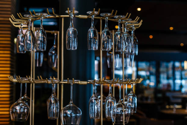 istock different glasses hanging over the bar. Soft focus 944990900