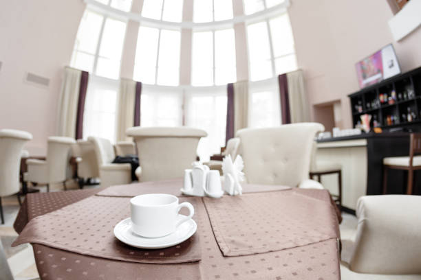 Coffee white cup for breakfast in restaurant with hotel background. Breakfast concept.