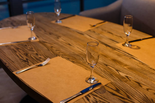 istock Glasses, forks, knives, plates on a table in restaurant served for dinner 944991968