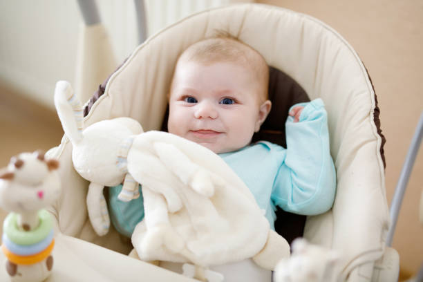 istock Cute adorable newborn baby sitting in swing 944992076