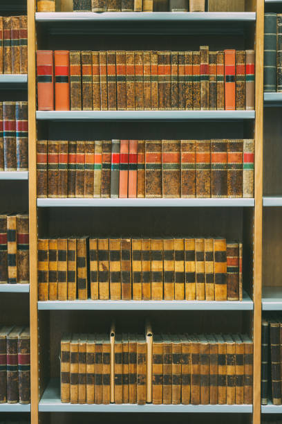 istock Aged Ancient Antique Old Vintage Books On A Shelfs In Library 944992824