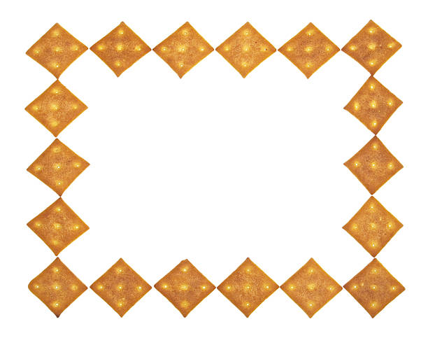 Small border of crackers Frame of the crispy crackers on a white background.  ortogonal stock pictures, royalty-free photos & images