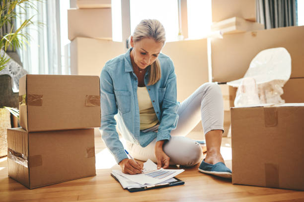 You can never be too organized on packing day Shot of a mature woman going through paperwork on moving day never stock pictures, royalty-free photos & images