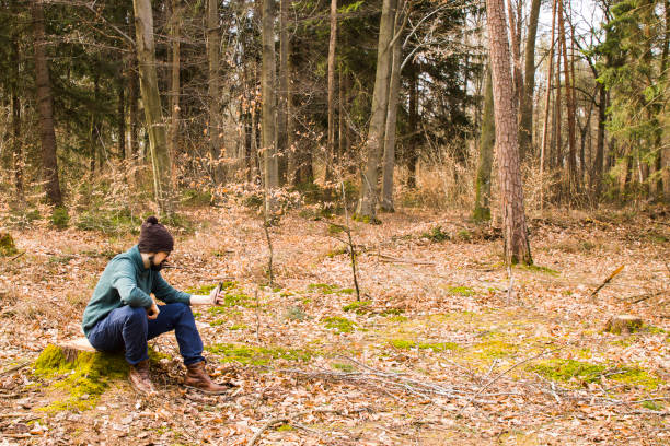 istock man taking photo with smartphone in the forest 945004924