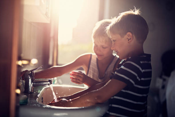 little boys washing hands - washing hands hygiene human hand faucet imagens e fotografias de stock