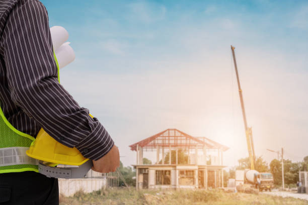 istock Asian business man construction engineer worker at house building site 945007740