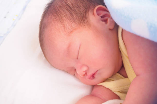 istock Newborn baby girl sleeping 945007810
