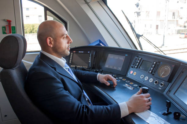 Train driver in cabin Portrait of middle aged man driving the modern train in Europe transport conductor stock pictures, royalty-free photos & images