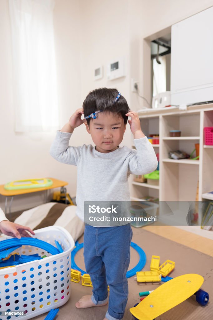 Little superman: toddler imitating adult Everyday life of toddler in house Child Stock Photo