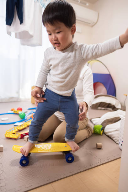 istock Toddler riding on skateboard 945016236