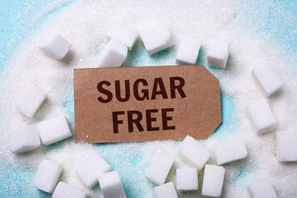 istock SUGAR FREE words on a green background with a bunch of sugar 945016368