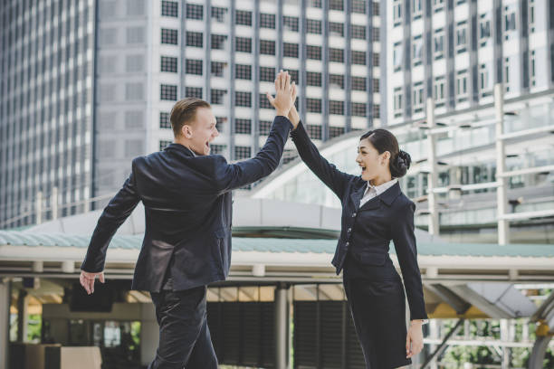 istock businessman and woman successful with work 945029446