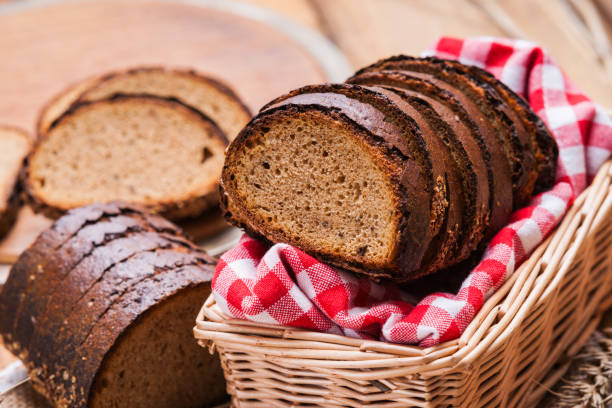 istock Sliced rye bread in a wicker basket and tablecloth 945032438