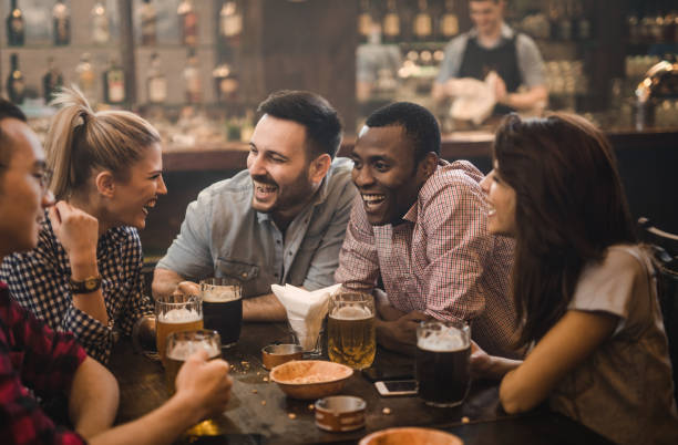 istock Cheerful friends talking during their night out in a pub. 945033164