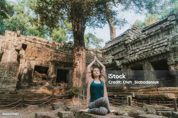 Woman Doing Yoga In Ta Prohm Temple Stock Photo - Download Image Now - Yoga, Cambodia, 20-29 Years
