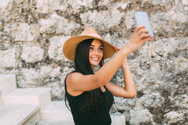 istock Beautiful brunette taking selfie 945037866