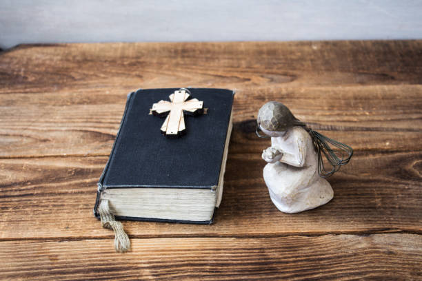 istock angel old bible and cross 945037950