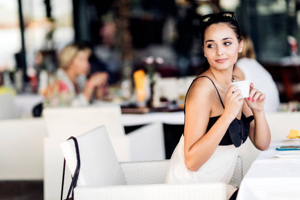 istock Attractive female drinking coffee from cup 945040822