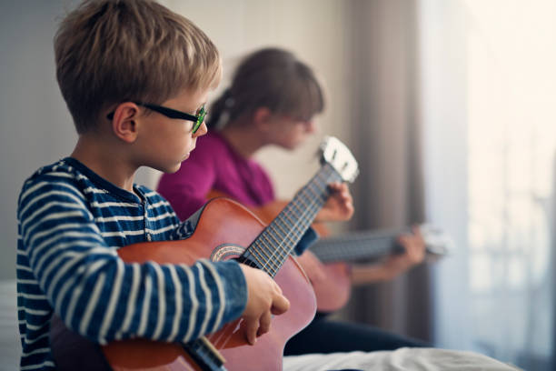 istock Kids playing guitars together 945041422