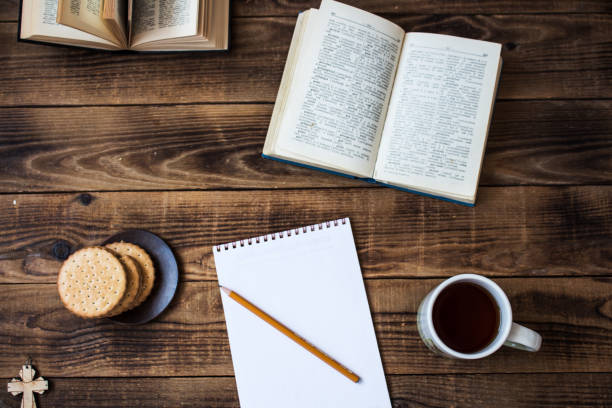 istock cookies and tea open book pencil notebook on wooden background 945041430