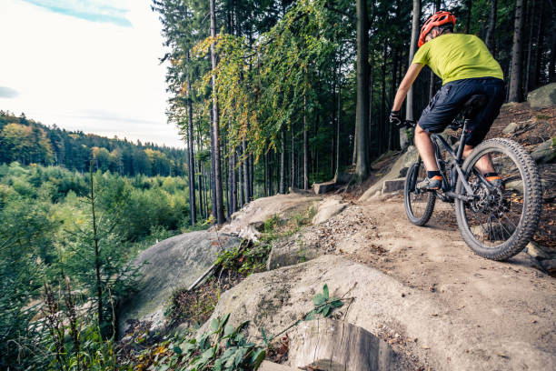 istock Mountain biker riding cycling in autumn forest 945041564