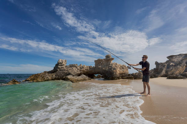 A young adult fishing at Hamelin Bay in Western Australia, a popular destination in Autumn for the Salmon migration.