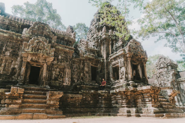 istock Man sitting  in Angkor Temple in Cambodia 945049048