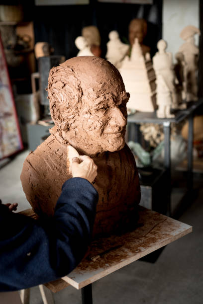 istock Sculptor's hand working on clay bust detail 945052272